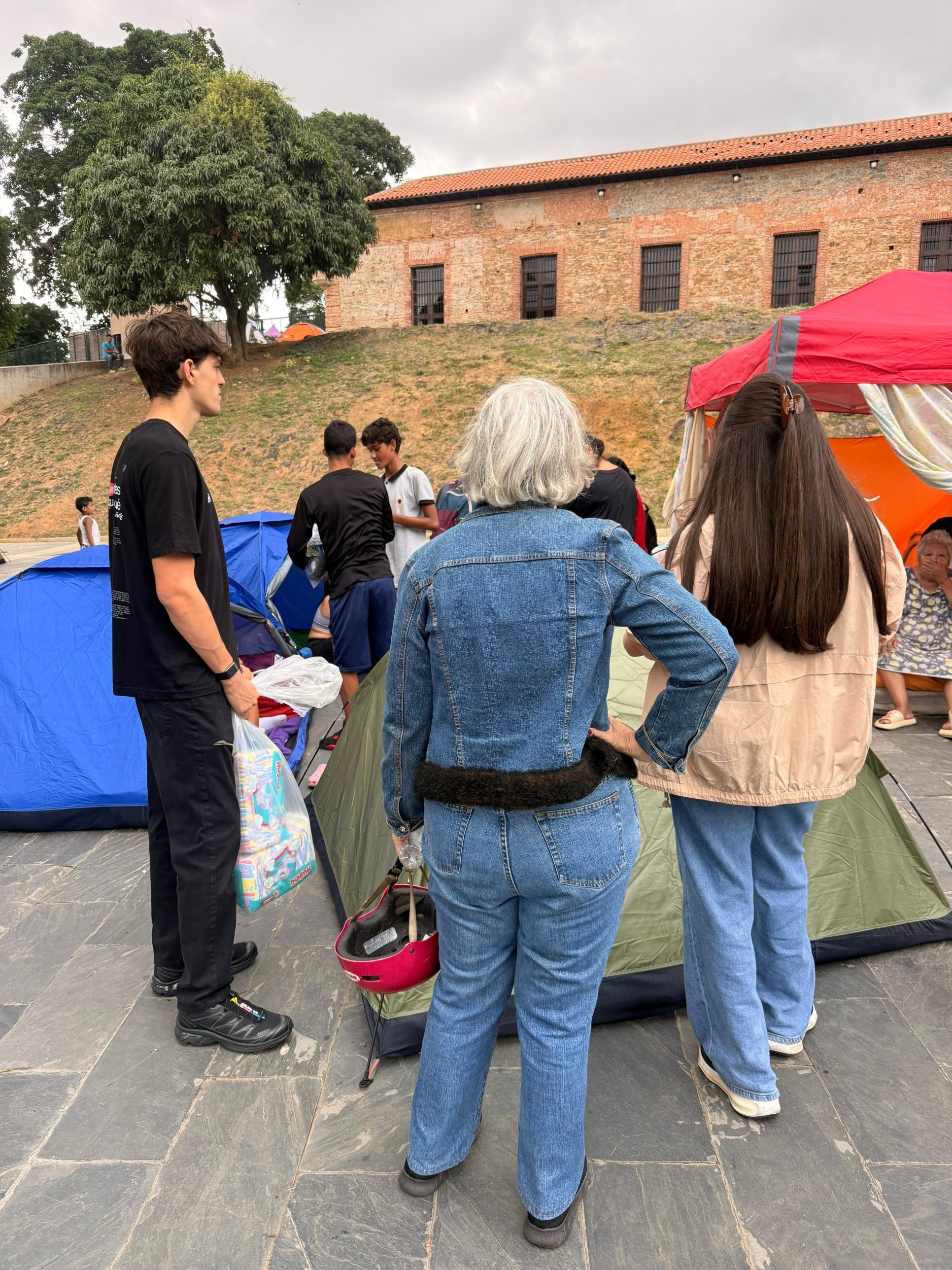 Volunteers handing out diapers at a tent camp for people displaced by the earthquake.